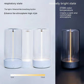 Modern cylindrical glass LED table lamp with white base, warm adjustable lighting, minimalist design.