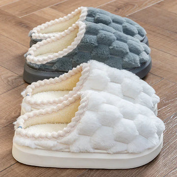 Plush slip-on slippers in gray and white, quilted texture, indoor cozy fit, on wooden floor