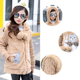 Girl wearing a beige faux fur hooded jacket with knit sleeves, animal pockets, relaxed fit.