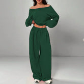 Woman wearing dark green off shoulder long sleeve top and matching wide-leg pants set