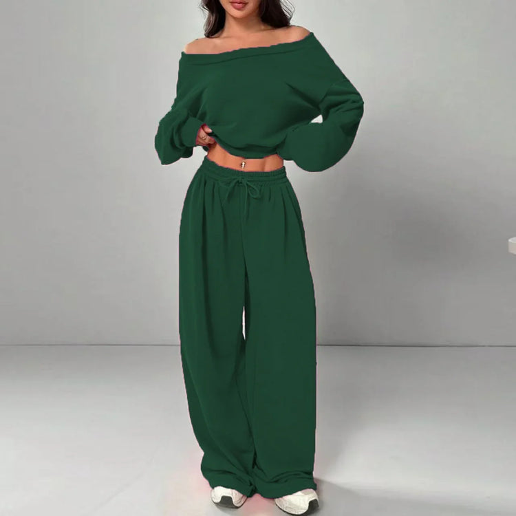 Woman wearing dark green off shoulder long sleeve top and matching wide-leg pants set
