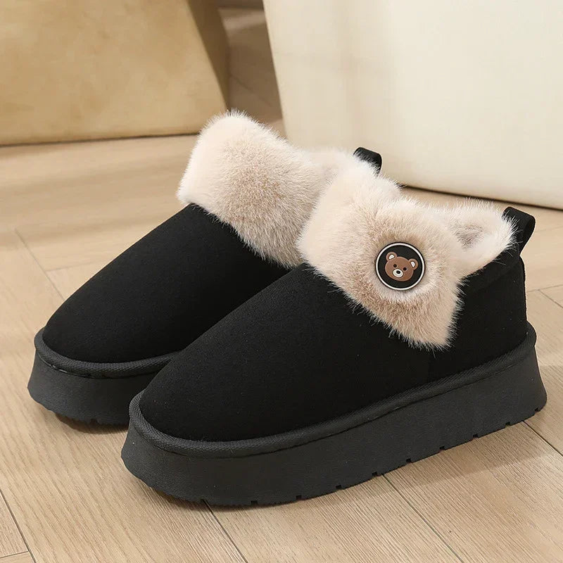 Black slip-on platform shoes with beige faux fur lining and bear detail, cozy streetwear style