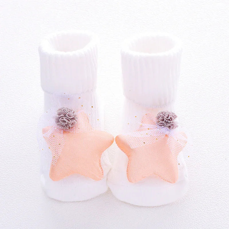 White ribbed baby socks with soft peach star decorations and delicate tulle accents