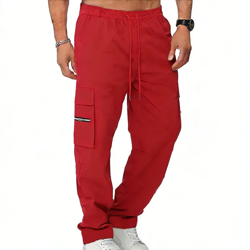 Red cargo jogger pants with side pockets, drawstring waist, relaxed fit, and casual streetwear style
