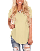 Woman in light yellow short sleeve V-neck top, relaxed fit, paired with ripped jeans