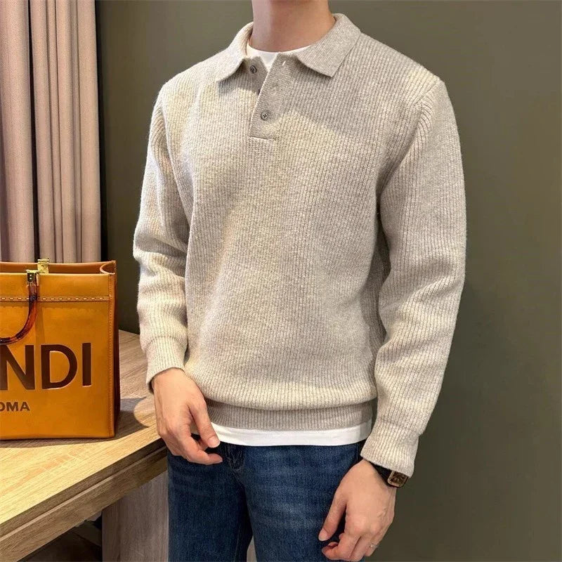 Man wearing a beige ribbed knit long-sleeve polo sweater with relaxed fit and blue jeans