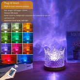 Crystal acrylic crown night light with RGB color options on wooden table, modern decor