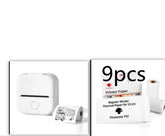 Compact white portable thermal printer with rolls of printer paper, minimalist tech accessory.