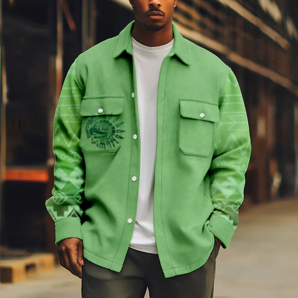 Man wearing a loose-fit light green corduroy shirt jacket with tribal print sleeves and chest pockets