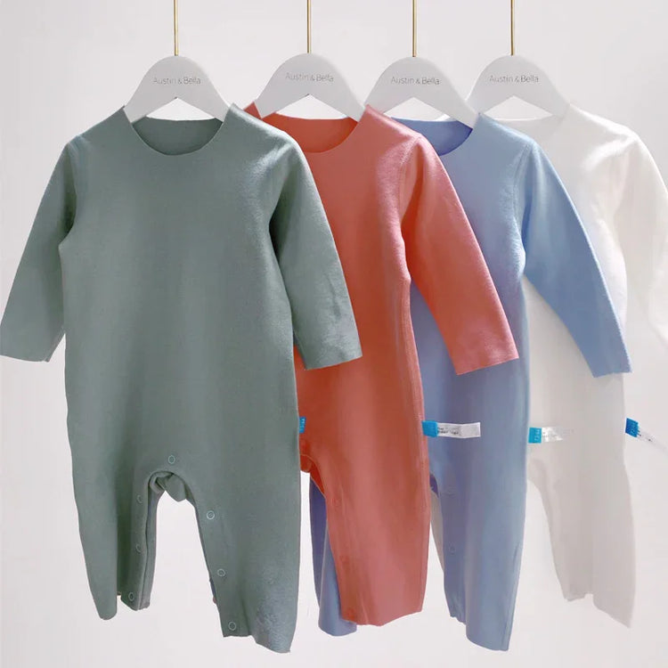 Long sleeve baby jumpsuits in green, pink, blue, and white, soft cotton, relaxed fit
