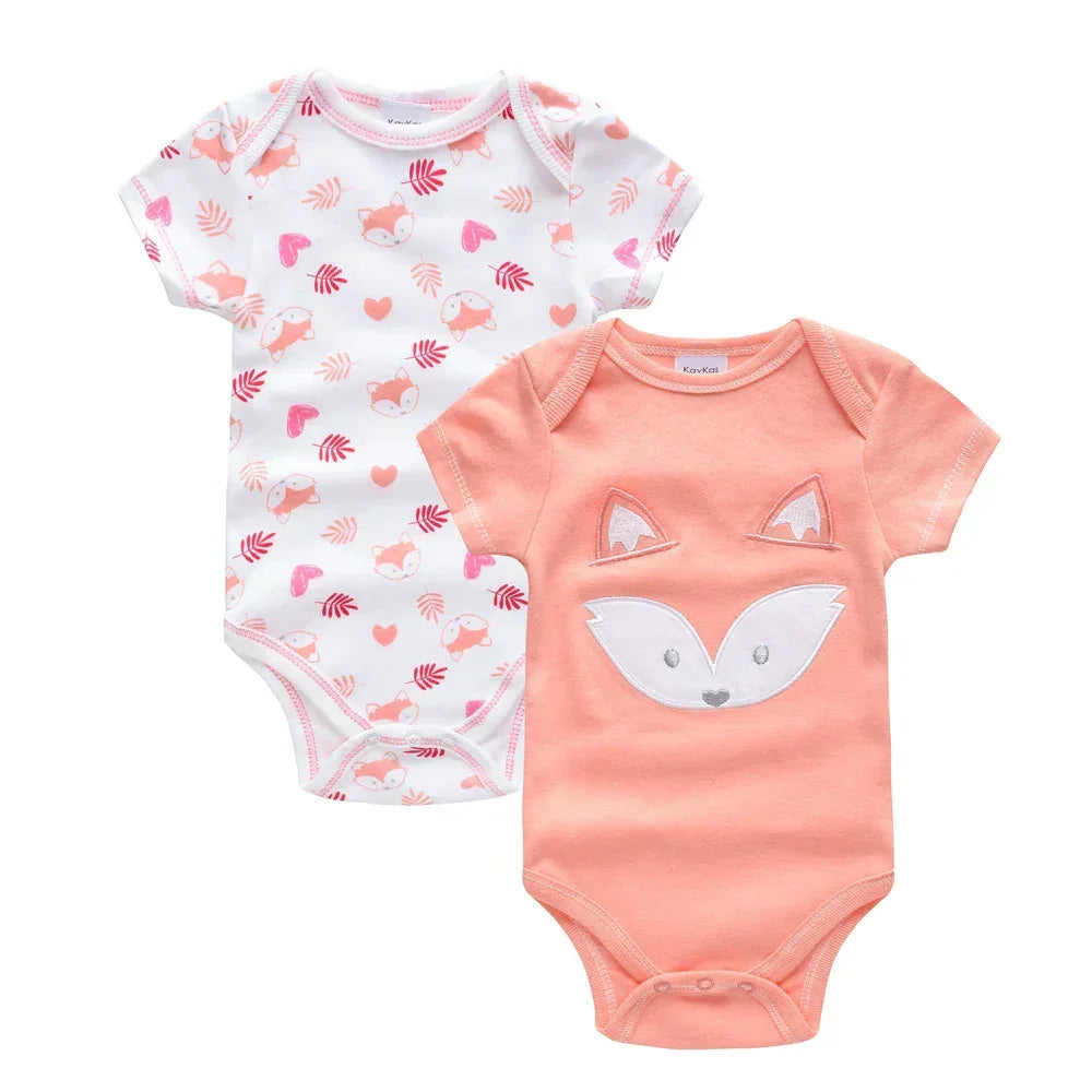 Two short-sleeve baby bodysuits, one peach with a fox design, one white with fox and heart print.