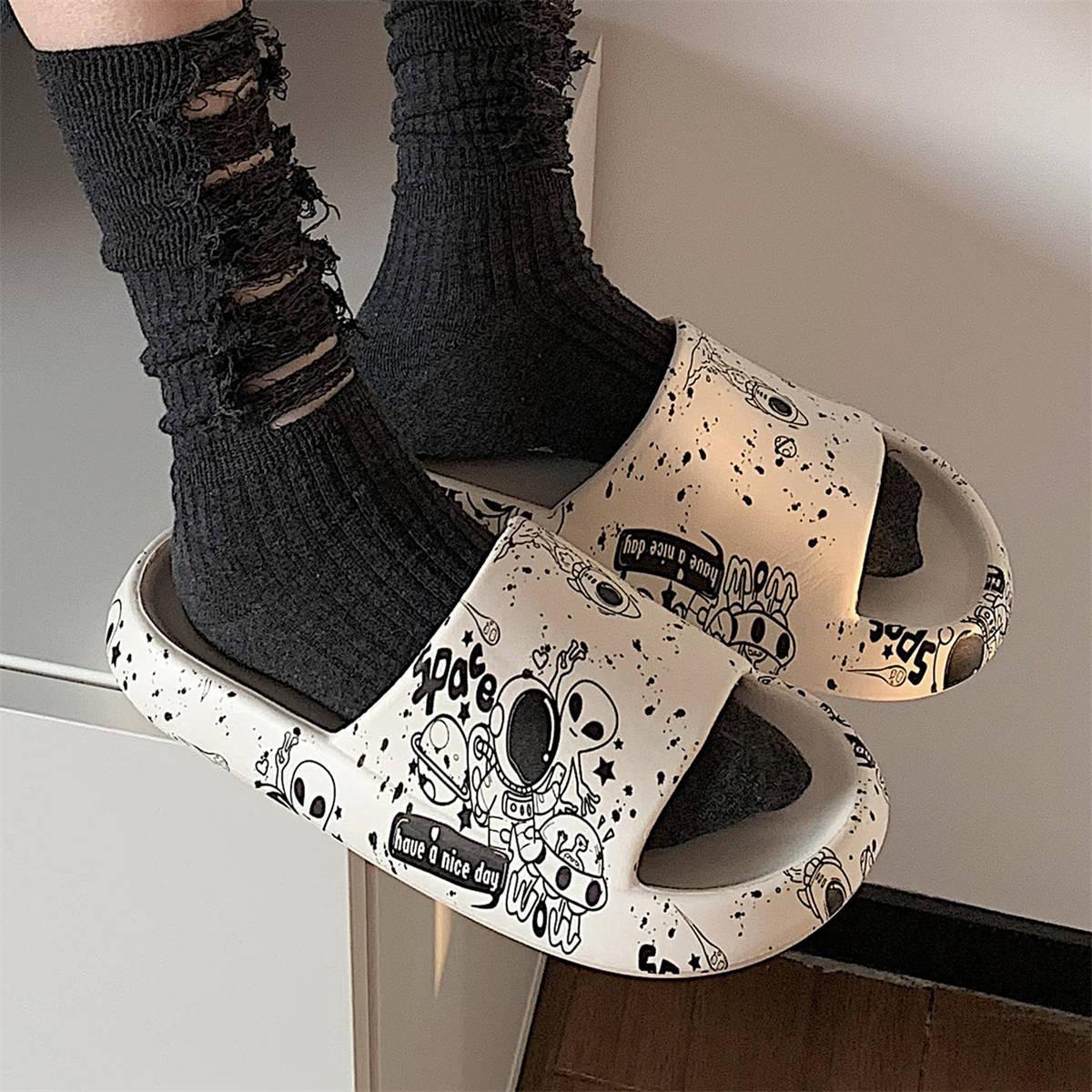 White graphic print slides with black distressed socks, casual streetwear style