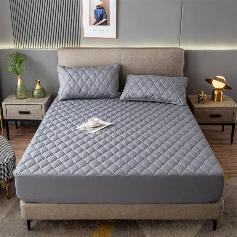 Modern bedroom with grey quilted bedding set, diamond pattern, fitted and sleek style