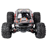 Black and red RC truck with oversized treaded tires and sporty off-road design
