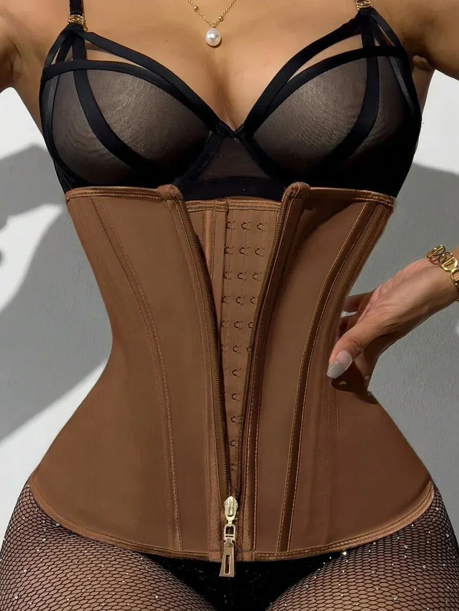 Woman wearing brown waist trainer corset with hook and zip closure, paired with sheer black lingerie and fishnet tights
