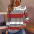 Woman wearing a red, white, and black striped long sleeve knit top with button accents, relaxed fit