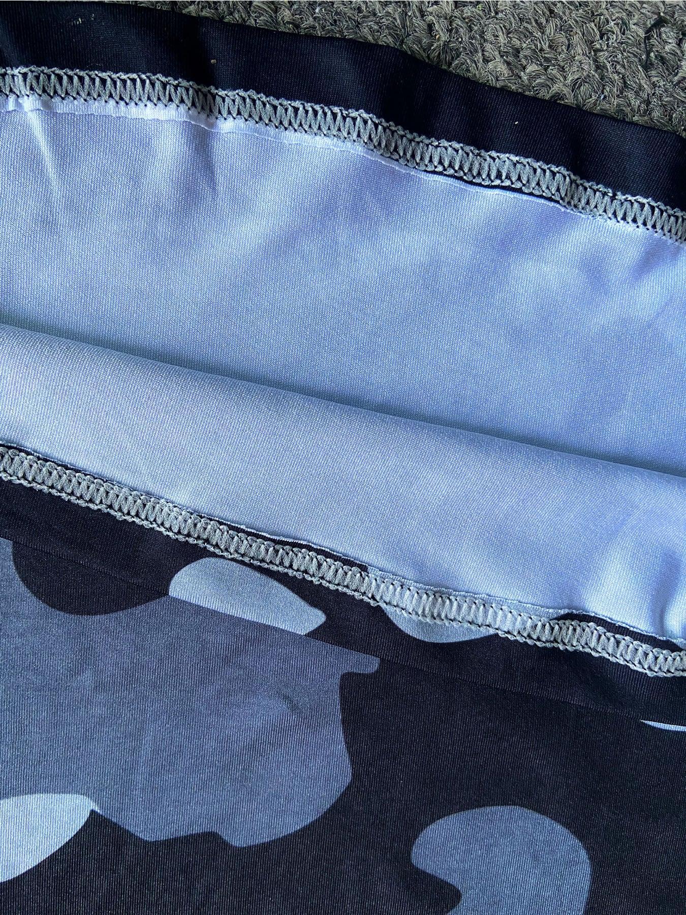 Close-up of blue and black camo pattern streetwear fabric with tight stitching detail