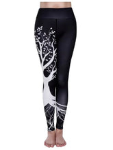 Black high-waisted leggings with white tree graphic, slim fit, stretchy material