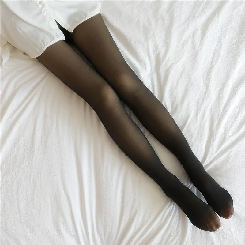 Sheer black tights with a slim fit, paired with a white shirt, on a white bed.