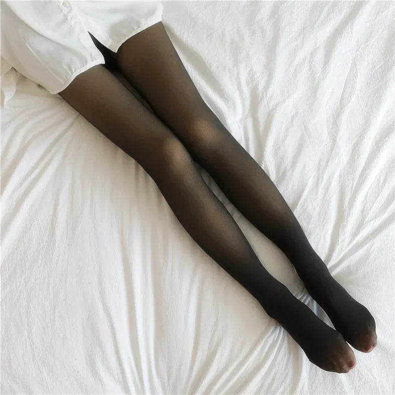 Sheer black tights with a slim fit, paired with a white shirt, on a white bed.