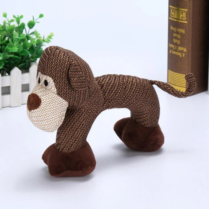 Stuffed brown monkey toy with textured fabric, soft plush feet, and tail on white background
