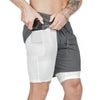 Gray athletic shorts with white compression liner, side pocket, and drawstring waist, showing fit and material