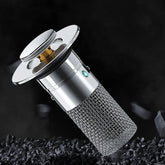 Silver cylindrical metal drain stopper with mesh filter, modern design, on black background