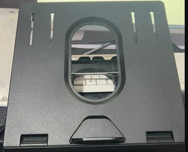 Black adjustable laptop stand with open slot and ergonomic design on desk