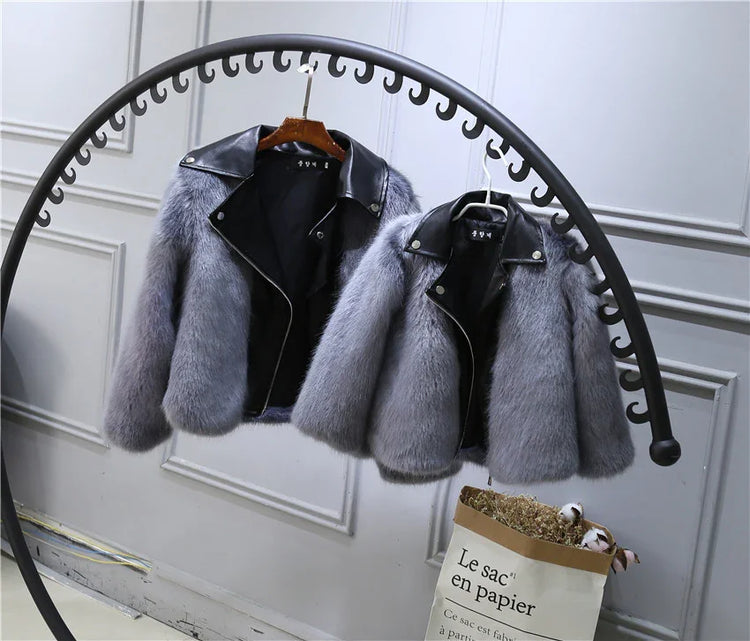 Gray faux fur jackets with black faux leather collars, modern cropped fit, hanging on rack