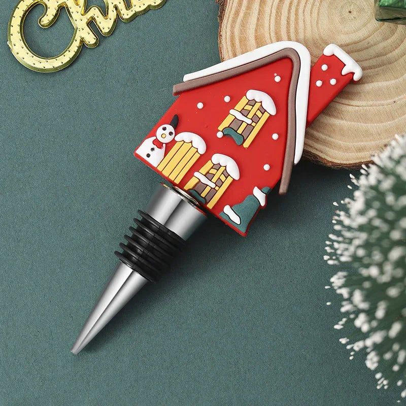 Festive wine bottle stopper with red snow-covered house design, silicone and metal materials
