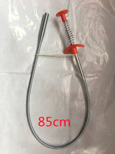 Flexible silver metal grabber tool with red handle, 85cm length, displayed on white surface