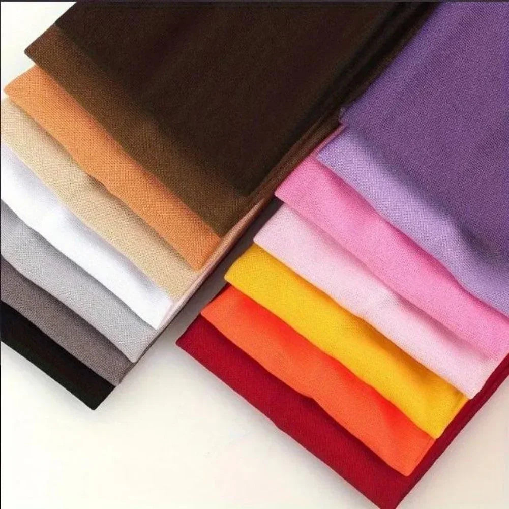 Stack of colorful cotton fabric swatches in various colors and smooth texture