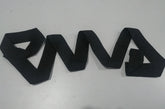 Black textured fabric belt arranged in geometric zigzag shape on a light surface