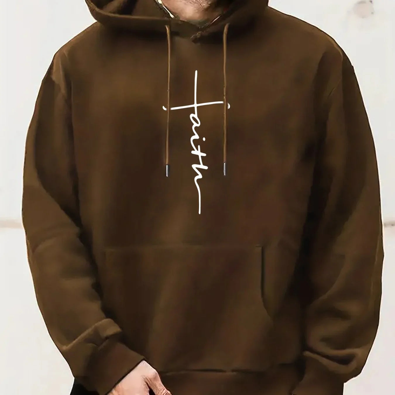 Brown oversized hoodie with white faith graphic, long sleeves, and kangaroo pocket
