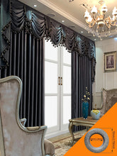 Elegant living room with dark velvet drapes, swag valance, and crystal chandelier