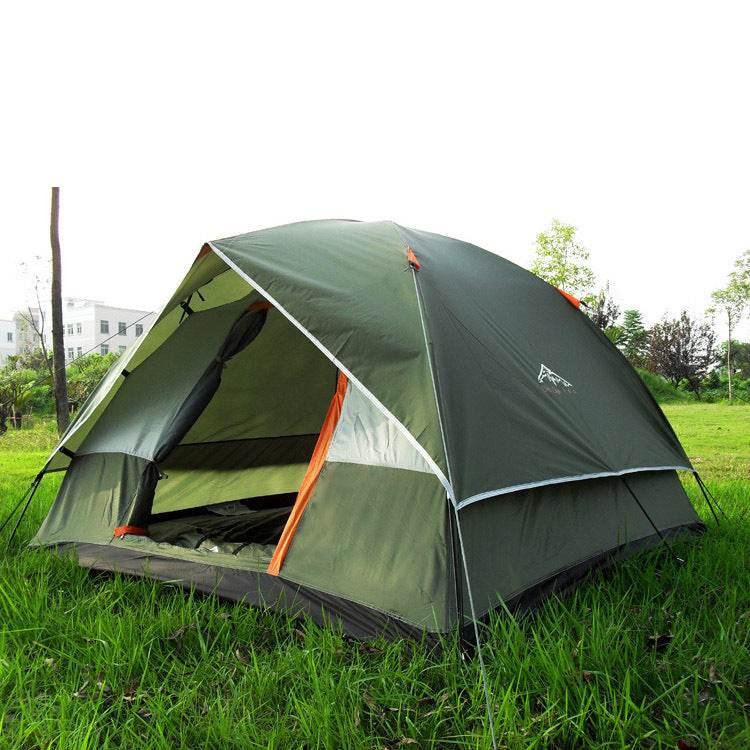 Green dome-style outdoor tent with orange accents, waterproof fabric, pitched on grass