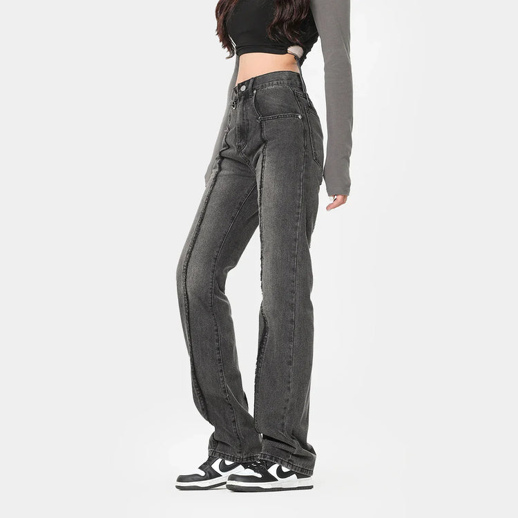Woman wearing high-waisted black wash straight leg jeans, relaxed fit streetwear style