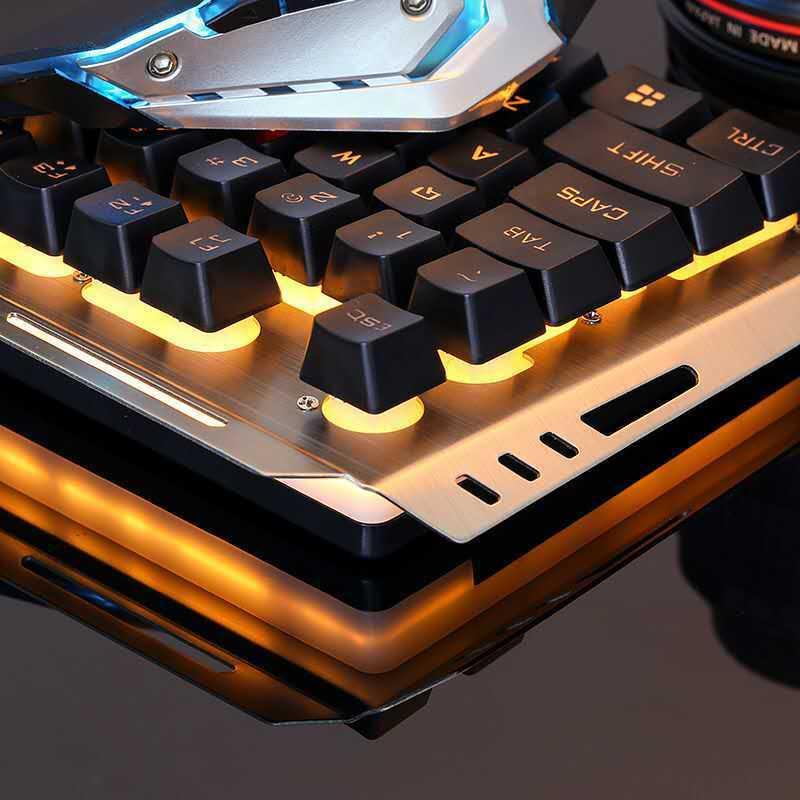 Close-up of black mechanical keyboard with orange LED backlight and metallic top plate