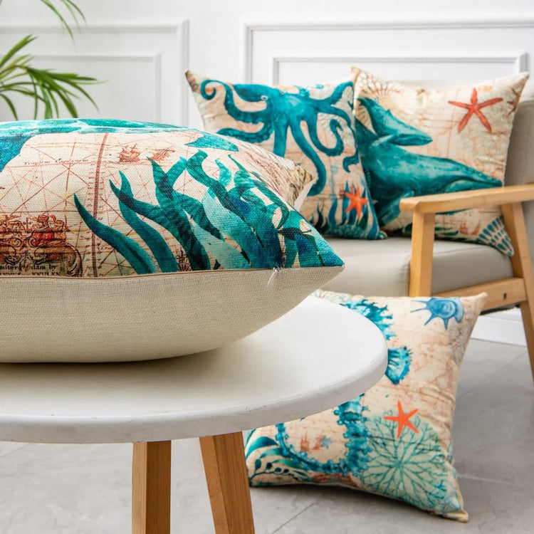 Colorful ocean-themed throw pillows with teal sea creatures on linen fabric, modern home decor