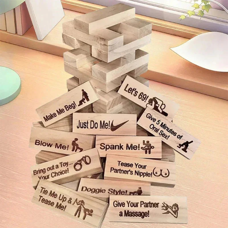 Stack of wooden Jenga blocks with adult-themed engraved tasks, playful couples game.