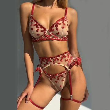 Sheer mesh lingerie set with red floral embroidery, underwire bra, garter belt, and thong