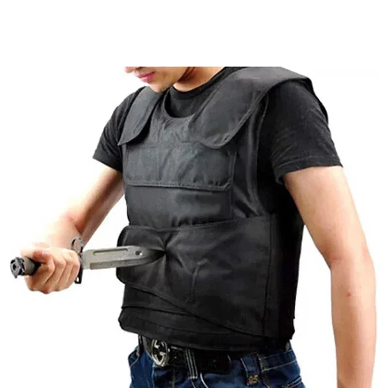 Man wearing black tactical vest with padded shoulders, demonstrating protective fit