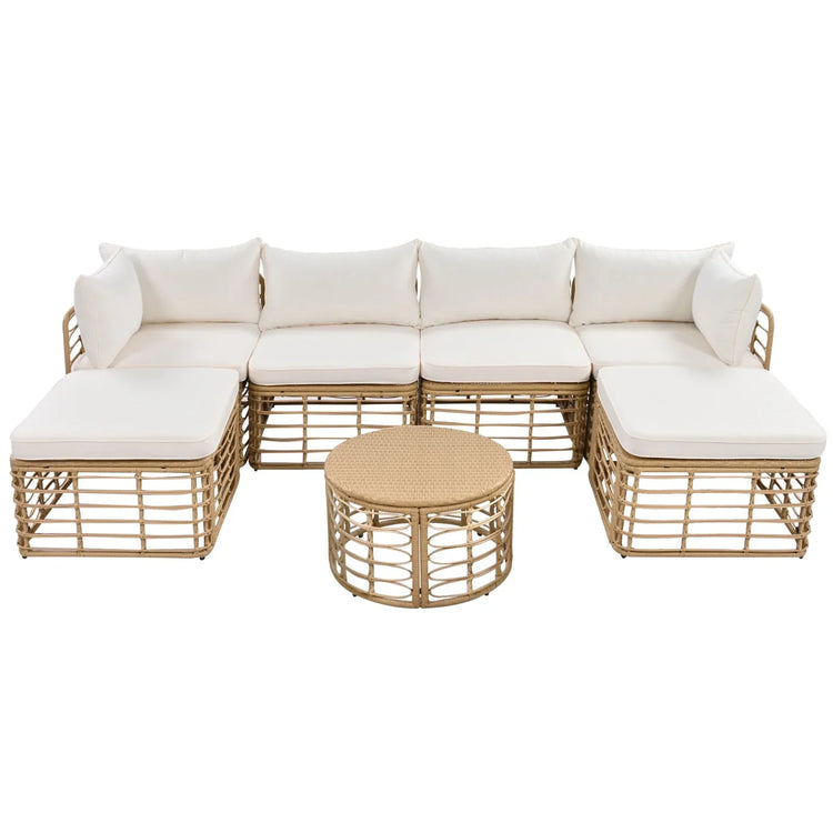 Beige rattan modular outdoor sofa set with white cushions and round wicker coffee table
