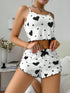 White ribbed pajama set with black heart print, spaghetti straps, relaxed fit, ruffled hems