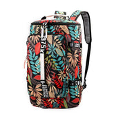 Colorful leaf print backpack with black, red, blue, and beige pattern, large front pocket, adjustable straps