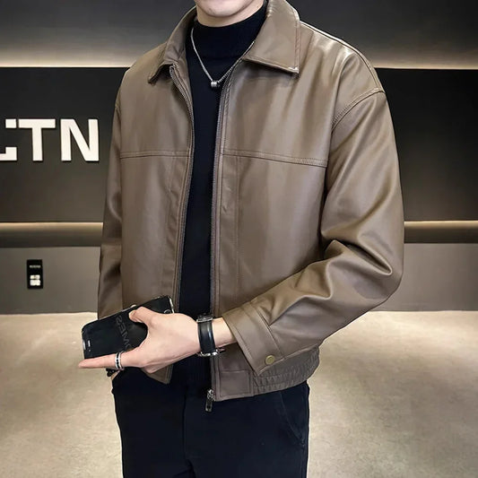 Man wearing a brown faux leather bomber jacket with relaxed fit and classic collar