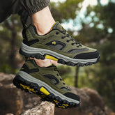Olive green trail hiking shoes with mesh panels, rugged rubber soles, and black accents outdoors