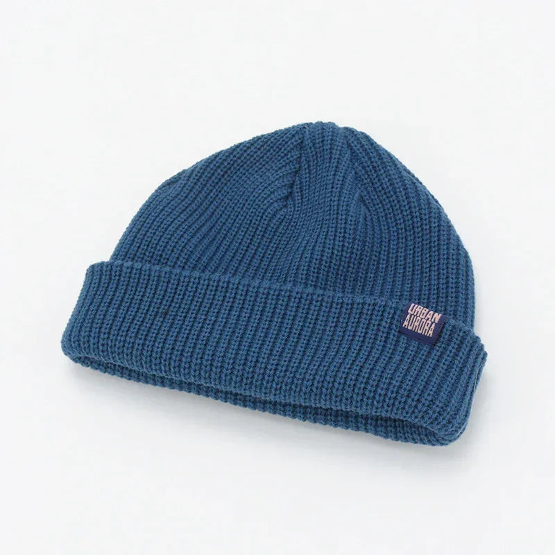 Blue ribbed knit beanie with folded cuff, soft wool material, relaxed streetwear fit