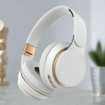 White over-ear headphones with gold accents, cushioned ear pads, modern minimalist style
