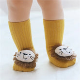 Yellow ribbed baby socks with plush lion face details, soft cotton material, cozy fit